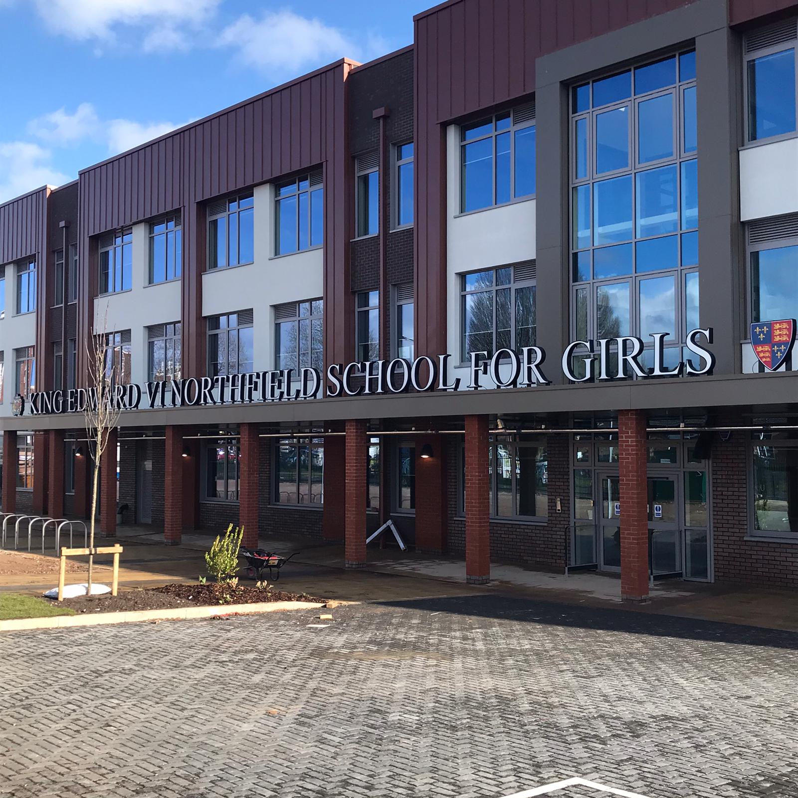 Built-up school lettering and logo installed on an education building